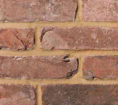 a close up of a brick wall that has been made with red bricks and mortar