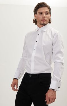 Pure Cotton Stud Button French Cuff Tuxedo Shirt is the most classical option, and the way to go for the minimalist taste. It is a tribute to the historical classical top three buttons tuxedo shirt setup. The shirt stud is a piece of jewelry that is essentially used in place of buttons and they come with the shirt. These studs can be replaced with our precious metals and crystals studs if desired. The metal studs are usually required in formal events, they are passed through two buttonholes, one Formal Single-button Tuxedo With Lapel Collar, Semi-formal White Shirt With Button Closure, White Single-button Tuxedo With Suit Collar, Tuxedo Studs, Tuxedo Shirt, French Cuff, Tuxedo Shirts, Men Shirt Style, Making Shirts