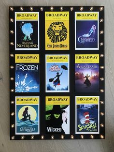 there are many movie posters on the wall with lights around them, and one is for broadway