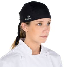 a woman wearing a chef's hat and white coat with black writing on it