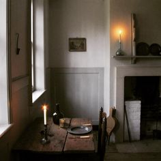 a table with a plate on it in front of a fireplace