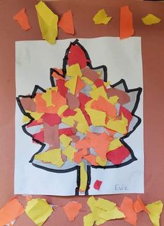 the paper is cut out to look like a leaf and leaves are scattered around it