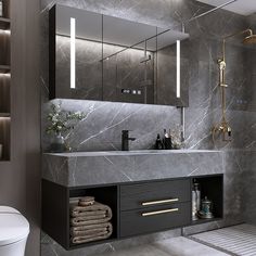 a bathroom with grey marble and gold accents