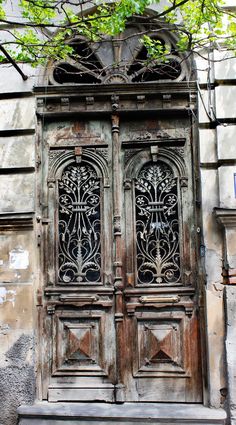 an old wooden door with wrought iron work