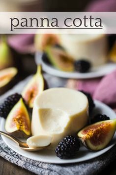 a white plate topped with sliced figs and yogurt next to blackberries