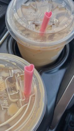 two cups filled with liquid sitting on top of a stove