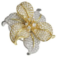 Exquisite 18 Karat White Gold Orchid Flower Ring Featuring 295 Round Brilliant Cut Diamonds of SI Clarity and G/H Color Totaling Approximately 2.00 Carats with Yellow Gold Accents. Three Dimensional Design Measuring 1.25 Inches in Diameter with Branch Detail on Band. Finger Size 6.5. Finished Weight is 13.8 Grams. Luxury Flower Shaped Jewelry With Pave Setting, Formal Flower Shaped Jewelry With Pave Setting, Elegant Yellow Flower Shaped Ring, Elegant Yellow Flower-shaped Ring, Gold Orchid, Diamond Huggies, Pave Diamond Ring, Gold Cocktail, Diamond Cocktail Rings