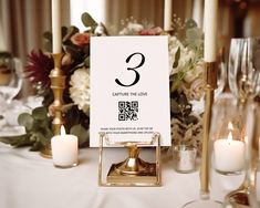 the table is set with candles, flowers and a sign that says 3 capture the love