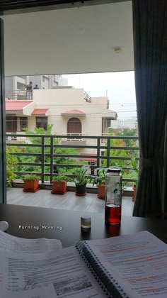 an open book sitting on top of a table next to a window