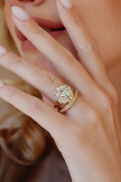 a close up of a person with a ring on their finger and her hand near her face