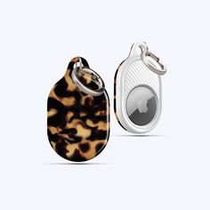 an animal print case with a keychain attached to the front and back of it