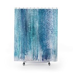 a shower curtain with blue and white watercolors on the outside, in front of a