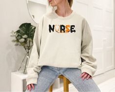 This nurse sweatshirt is perfect for any RN. It's comfortable and stylish, and it makes a great new nurse gift. Plus, it can be personalized with your own name or initials. It's also the perfect way to show your appreciation for all that a Registered Nurse does. Order yours today! 🕕Production Time 1-2 business days🕕 All Sweatshirt belongs to Gildan brand  High quality and super soft, comfortable shirt. Made with top of the line vinyl and pressed with a professional grade heat press. ✔Make sure Jesus Clothing, Christian Crewneck, Mama Sweater, Personalized Sweater, Animal Sweatshirt, Mama T Shirt, Nurse Sweatshirt, Mothers Day T Shirts, Christian Apparel