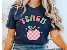 Elevate your Kindergarten or preschool Teacher apparel with this Retro teacher shirt. Design features a retro apple with TEACH across the top,  perfect for a new teacher gift, back to school shirt, first day of school teacher shirt or a gift for a librarian. Give as a gift for teacher appreciation week. **Check out my Etsy shop for more teacher gift ideas https://www.etsy.com/shop/DesertSunriseShop?ref=dashboard-header§ion_id=48532573 PRODUCT Bella and Canvas 3001 Unisex Adult Short Sleeve Tee H Trendy Fall T-shirt For School, Trendy Teacher Appreciation T-shirt For Back To School, Trendy School T-shirt For Fall, Teachers Appreciation Week Gifts, New Teacher Gifts, School Tees, Teacher Tees, Teacher Appreciation Week, New Teachers