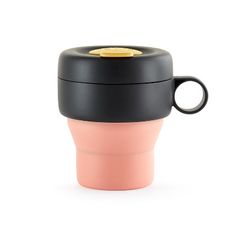 a black and pink coffee cup with a gold lid is shown against a white background