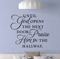 a wall decal with the words until god opens the next door, praise him in the hallway