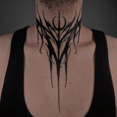 a man wearing a black shirt has a tattoo on his neck