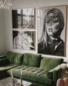 a living room with green couches and pictures on the wall