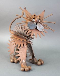 a metal cat sculpture on a gray background