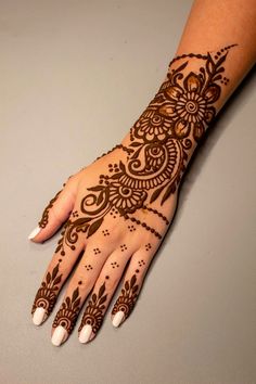 a henna tattoo on the palm of someone's hand