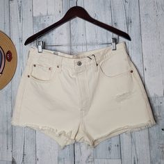 Levi's Women's Shorts High-Rise Fitted Through Hip And Thigh. 100% Cotton Waist 17" Inches Rise 12" Inches Inseam 2.5" Inches Cream High Rise Relaxed Fit Bottoms, High Rise Beige Shorts For Spring, High-rise Beige Shorts For Spring, Levi's High Waist Summer Shorts, Levi's Summer Cutoff Shorts, Levi's Summer Shorts, High Rise Beige Shorts For Summer, High Rise Beige Bottoms For Summer, White Levi's Bottoms For Summer