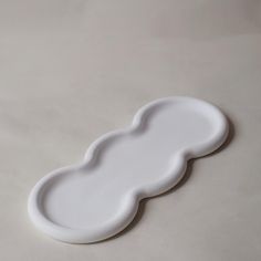 a white plate sitting on top of a table next to a black and white object