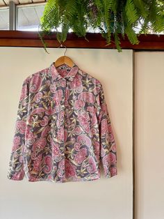 "Awesome 90's paisley leaf print button up long sleeve blouse. Marked a size Large. 100% Cotton. Purple, pink, green, gold, and blue. Great muted color combo. Great color combo. Comfortable and easy to wear. In good vintage condition. So cute! Measurements taken while item was laying flat. Bust: 22\" Length: 25\"" Fall Patterned Cotton Blouse, Long Sleeve Blouse With Floral Print And Relaxed Fit, Fall Cotton Shirt With Paisley Print, Cotton Button-up Top With Floral Print, Fall Cotton Blouse With Vintage Print, Floral Print Cotton Button-up Tops, Cotton Floral Print Button-up Top, Pink Paisley Print Long Sleeve Blouse, Long Sleeve Printed Cotton Blouse