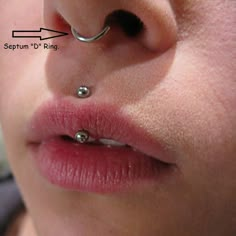 a close up of a person with piercings on their nose and behind the ear