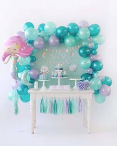 a mermaid themed birthday party with balloons and decorations