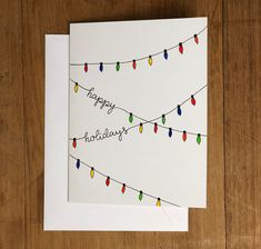 a happy birthday card with christmas lights on the string and handwritten words that read happy holidays