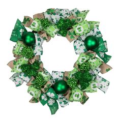 Add a whimsical touch to your St. Patrick's Day decorations with this fun ribbon wreath. Shamrock and leprechaun hat ribbons surround glittery shamrocks and green ornaments. Perfect on doors walls or mantles. Features: Green and white festive ribbons Glittered shamrocks with green ball ornaments Recommended for indoor use only - if using outdoors place under a covered area No assembly required - wreath comes in 1 piece Dimensions: 24" diameter (measured from outermost edge to outermost edge acro Green Ornaments, Leprechaun Hat, Material Wreaths, Leprechaun Hats, Tinsel Garland, St Patrick's Day Decorations, Artificial Wreath, Christmas Central, Ribbon Wreath