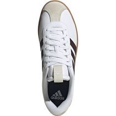 the adidas sneakers are white and brown with black accents on the upper part of the shoe