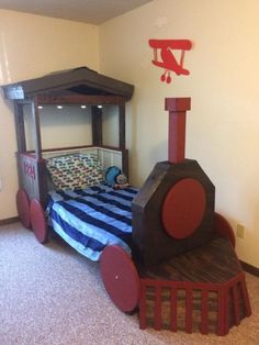 a child's bedroom with a bed made to look like a train