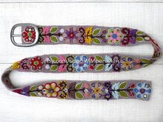 Peruvian embroidered belt floral natural organic dyes GRAYThese belts are densely embroidered using dozens of colors naturals and each one is unique. Elegant floral design and a pleasure to wear, it will bring joy to you through its visual beauty as you will want to wear it time and time again.Each belt 5 sets of holes spaced 2" apart so they are versatile. You can wear the same belt on your waist or hips. They also stretch slightly, like a pair of jeans, and will conform to your body after a fe Adjustable Multicolor Bohemian Belts, Bohemian Fabric Belt For Festivals, Handmade Bohemian Belt With Multicolor Embroidery, Bohemian Multicolor Belts For Spring, Bohemian Embroidered Belt For Spring, Bohemian Brown Fabric Belt, Adjustable Bohemian Fabric Belt, Bohemian Multicolor Embroidery Belts For Festival, Handmade Bohemian Multicolor Belt