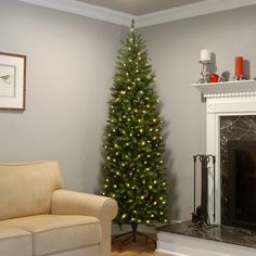 a living room with a christmas tree in the corner and a couch next to it