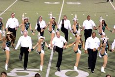 a group of cheerleaders perform on the field during a football team's game