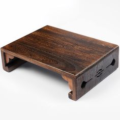 a wooden step stool with two holes in the bottom and one on the front side