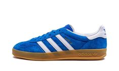 The adidas Gazelle Indoor “Blue Bird” is a vibrant blue colorway of the retro indoor soccer shoe by the German footwear company.  The classic silhouette’s suede upper is featured in a bright shade of blue that adidas has dubbed “Blue Bird. ” Contrasting white leather Three Stripes branding can be seen on each side.  A gold “Gazelle” logo appears on the lateral side of the shoe while classic adidas Trefoil detailing is seen on the heel.  More adidas branding is found on the tongue.  A semi-translucent gum rubber sole completes the look.  Release date: July 15, 2022 Adidas Shoes Gazelle, Bird Shoes, Adidas Gazelle Indoor, Nike X Travis Scott, Gold Adidas, Converse Run, Converse Run Star, Adidas Spezial, Adidas Trefoil