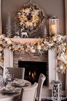 a dining room table set for christmas dinner with white and silver decorations on the mantle