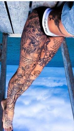 a man's leg with tattoos on it