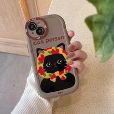 a person holding a cell phone case with a cat on it