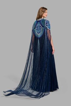 This princess-like Peacock Dress in tulle is carefully crafted with floral patterns and it’s design is further enhanced with embroidered sequins and bugle beads Free worldwide shipping! Embroidered Evening Dress With Cape Sleeves, Evening Dress With Embroidery And Cape Sleeves, Evening Dress With Embroidered Cape Sleeves, Blue Embellished Dress With Cape Sleeves, Embellished Dresses With Cape Sleeves For Reception, Party Dress With Intricate Embroidery And Cape Sleeves, Embellished Evening Dress With Cape Sleeves For Reception, Blue Sequin Dress With Cape Sleeves, Embroidered Tulle Evening Dress