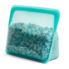 a blue container filled with nuts on top of a white table