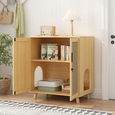 a wooden cabinet with books and other items in it