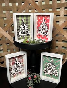 three christmas cards sitting on top of a black table