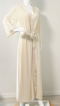 This is a lovely robe and night gown set from Vanity Fair.  The gown ties in the back.  The robe has an inner tie and a sash and one pocket.  Both pieces have inset lace.  Size tag M, nylon.   Measurements taken with robe and nightgown laying flat and doubled where appropriate. In order to determine fit we recommend comparing measurements with an item that fits you well. Gown Length 54 inches Underarm to underarm 34 inches Waist 30 inches Hips 38 inches Robe Length 55 inches Shoulder to shoulder Vintage Nightgown And Robe, Elegant Beige Sleepwear For Wedding Night, Elegant Long Nightgown For Sleep, Elegant Long Sleepwear, Elegant Open Front Daywear Robe, Elegant Cream Robe For Daywear, Elegant Beige Nightgown For Sleep, Elegant Long Nightgown For Loungewear, Feminine Long Robe For Wedding Night