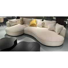 a large white couch with lots of pillows on it