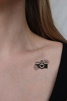 a woman with a camera tattoo on her chest