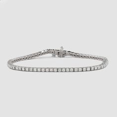 Named after women’s tennis champion Chris Evert, who lost a similar style on the 1987 US Open court, this flexible, close-set diamond bracelet comes adorned with a securely designed clasp that fluidly moves with every gesture (so it’ll stay with you forever). A perennial classic in every era, the single strand looks radiant alone for 1.8-carats of delicate sparkle and layers with other styles for a more subdued shimmer. Custom sizes are available upon request. Presented in our signature Noémie o Luxury Platinum Diamond Bracelet With Brilliant Cut, Timeless Tennis Bracelet With 17 Jewels, Luxury Tennis Bracelet With Round Cut For Formal Occasions, Luxury Round Cut Tennis Bracelet For Formal Occasions, Luxury Tennis Bracelet With Prong Setting, Timeless Tennis Necklace With Vvs Clarity, Platinum Tennis Bracelet With Diamond Accents, Luxury Platinum Tennis Bracelet With Single Cut Diamonds, Classic Diamond Bracelet With 17 Jewels