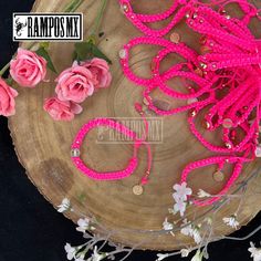 pink beads and flowers on a wooden plate